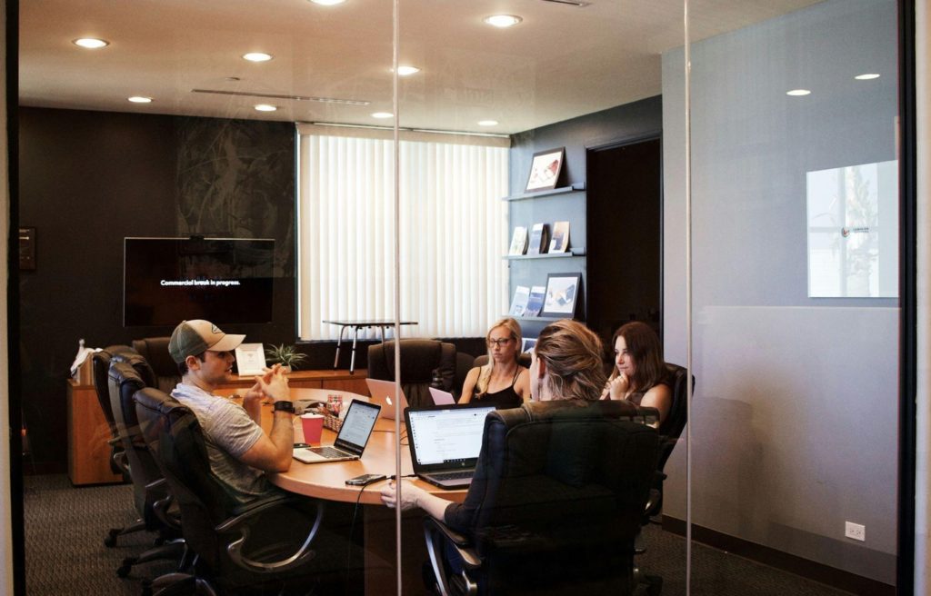 People-at-meeting-table-with-laptop-image-by-